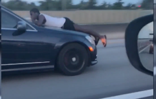 What in the Florida? Video Shows Man Riding on the Hood of Speeding Car on I-95 What in the Florida? Video Shows Man Riding on the Hood of Speeding Car on I-95